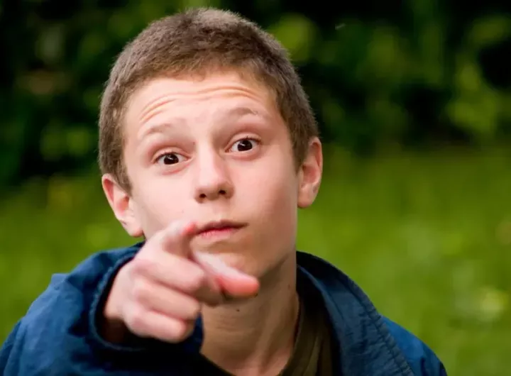 boy points at camera accusingly