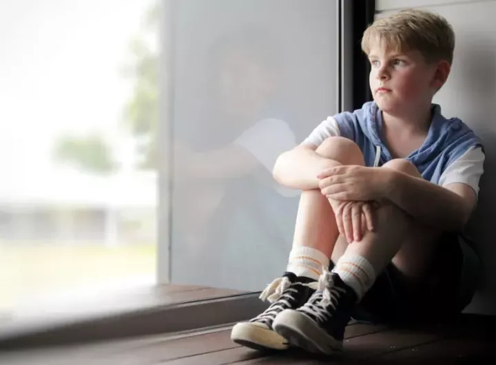 boy staring out window