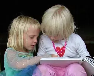 two girls reading book