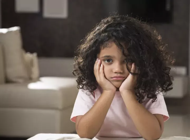 little girl with bored expression on her face