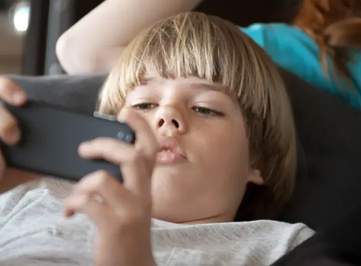 Boy playing on smart phone