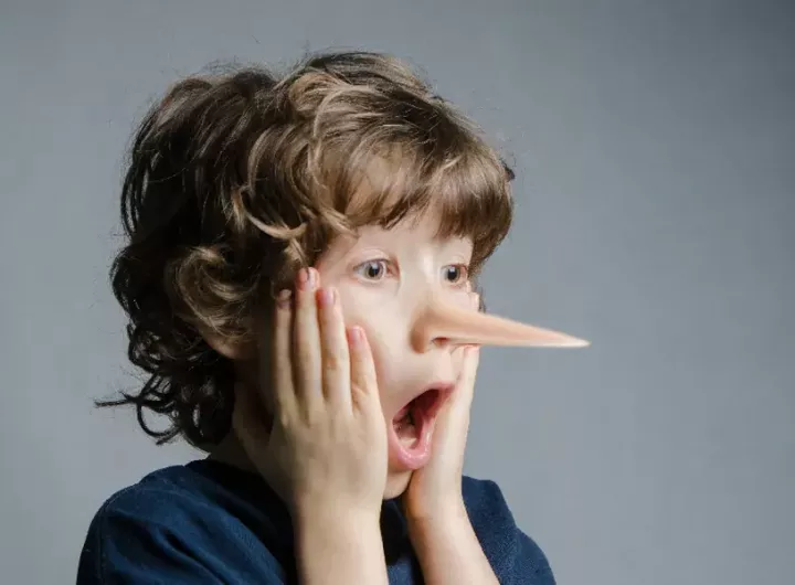 Boy in shock as his nose has grown like Pinocchio's